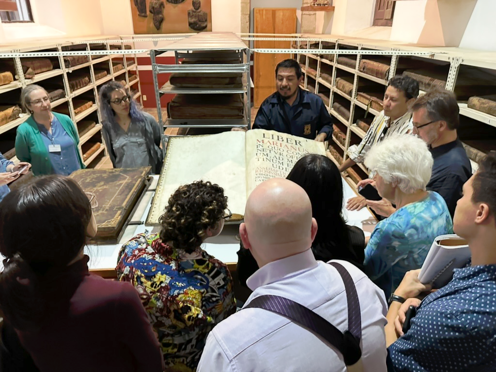 Professor shows students large antique antiphony.